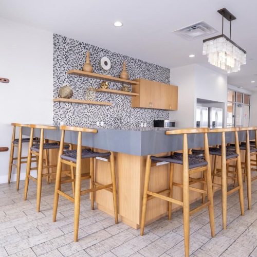 a room with a bar and chairs